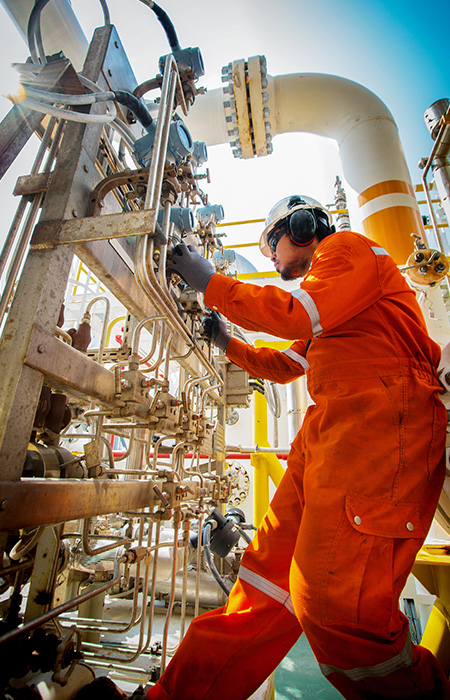 Worker inspecting bolts