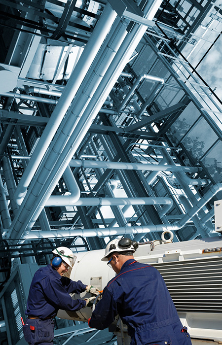 Worker inspecting bolts